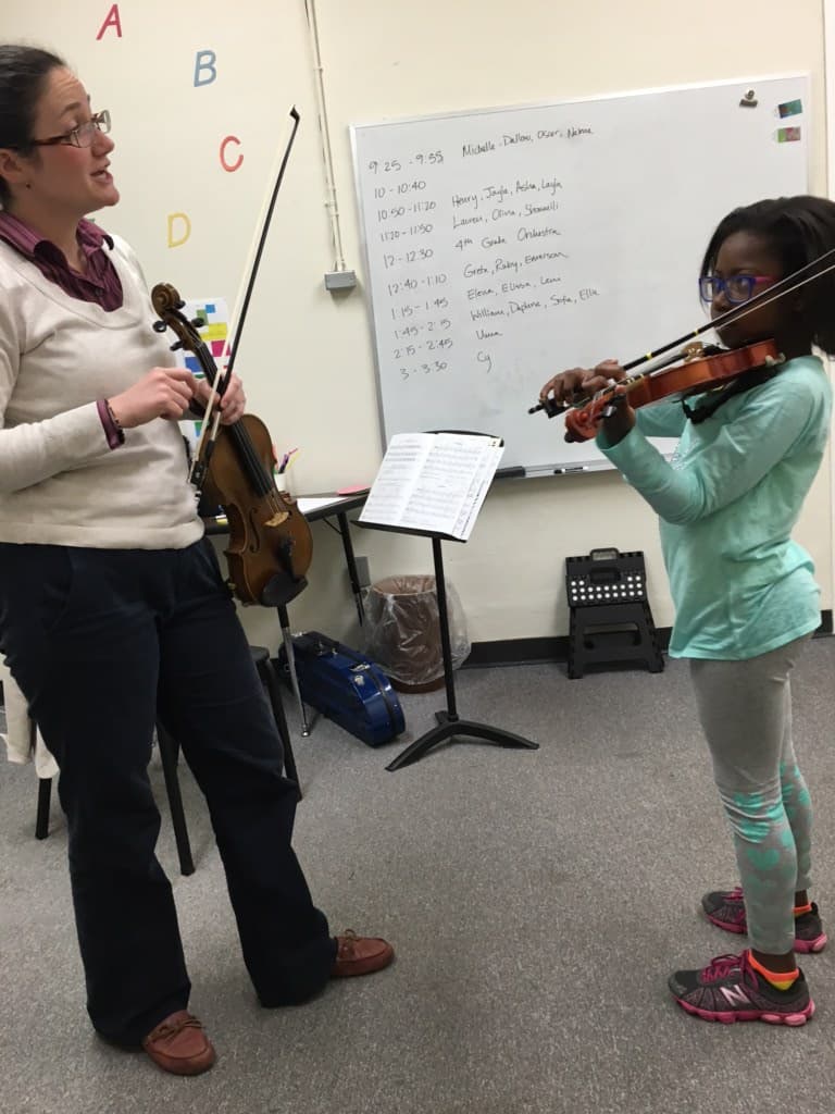 A young Michelle-Dallow Elliott beginning her violin journey